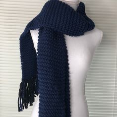 a mannequin wearing a blue knitted scarf