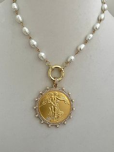 This is a gorgeous high luster, white porcelain pearl, French Commemorative coin Necklace. The porcelain glass, replica potato shaped freshwater pearls are strung together with gold wire making this a stunning piece of jewelry. The reproduction coin pendant, a French Commemorative medal coin is surrounded by Cubic Zirconia stones and pearls. It elegantly hangs from a gold, spring lock clasp with CZ accents. The bale attached to the coin is also encrusted with CZ stones. A stunning Art Deco/Antiq French Coins, Sterling Necklace, Coin Pendant Necklace, Antique Inspiration, Gold Coin, Coin Jewelry, Jacksonville Fl, Gold Wire, Coin Necklace