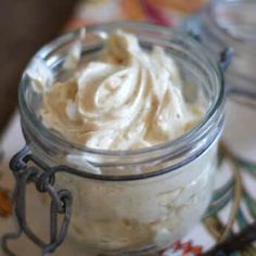 a jar filled with whipped cream sitting on top of a table