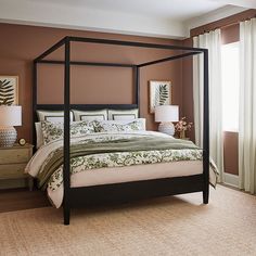 a bedroom with a four poster bed and brown walls