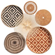 woven baskets are arranged on top of each other in different patterns and sizes, with one basket hanging from the ceiling