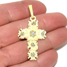 A vintage Alpine souvenir - a cross made from Edelweiss blooms carved out of bone. The flowers have carved petals and the center of each blossom is touched up in gray, black, and yellow paint. The cross has a carved ring at the top for hanging, and is attached to a celluloid bail.  The cross is in excellent condition and measures 4.6 cm tall ( including the bail), and 2.4 cm wide. A nice souvenir of a trip to Switzerland or another Alpine area. Edelweiss Jewelry, Edelweiss Flower, Carved Ring, Yellow Painting, Touch Up, Cross Pendant, Jewelry Necklace Pendant, Carving, Jewelry Necklaces