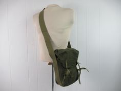 "Unique vintage 1940s WWII era green cotton canvas shoulder bag. Has unique tie down closures. Maybe a hunting bag or military bag. No manufacturer's label. Bag measures 12\" tall, 8\" wide and 4.5\" thick. In very good condition with name written in marker on the strap." Vintage Green Satchel With Adjustable Strap, Vintage Cotton Satchel For Daily Use, Vintage Waxed Canvas Shoulder Satchel, Vintage Khaki Canvas Satchel, Vintage Khaki Satchel For Daily Use, Vintage Khaki Cotton Bags, Vintage Waxed Canvas Shoulder Bag, Vintage Green Canvas Shoulder Bag, Vintage Khaki Canvas Satchel Bag