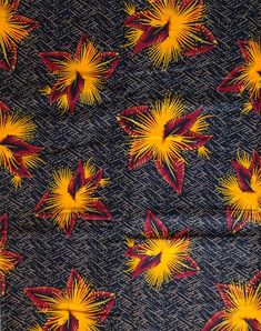 the fabric has yellow and red flowers printed on it, as well as dark blue background