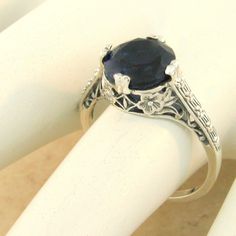 Vintage Estate 2 Carat Simulated Sapphire Solitaire Filigree Ring. 925 Solid Sterling Silver. The Top Of The Ring Measures 3/8 Inches In Length. Stamped 925. Excellent Condition/Like New. Fine Jewelry Sapphire Ring For Wedding With Intricate Design, Sapphire Ring With Intricate Design For Wedding, Wedding Sapphire Ring With Intricate Design, Filigree Round Jewelry For Marriage, Filigree Jewelry For Marriage, Elegant Sterling Silver Sapphire Ring With Round Stone, Elegant Sterling Silver Sapphire Wedding Ring, Classic Sapphire Ring With Intricate Design For Anniversary, Wedding Filigree Ring Hallmarked Fine Jewelry