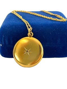 "Description: Lovely Art Nouveau Era gold filled round photo locket on a 12K gold filled chain. The locket front features an etched starburst shape that is set with a clear round diamond stone set in the very center of the circular pendant. The back of this vintage locket has a shiny finish and has a monogram \"JG\" in swirling cursive letters.  Inside the locket there are two places for photos. Currently they are both empty.  Both original frames and photo covers remain. The W&H hallmark on the inside of this locket stands for the Wightman & Hough Company that was established in 1856 in Providence, Rhode Island. They manufactured gold-filled, rolled gold, and sterling silver jewelry. Each piece was hallmarked with a heart containing the initials \"W&H CO\". They were  known for lockets, m Vintage Locket, Round Locket, Cursive Letters, Vintage Lockets, Photo Necklace, Photo Locket, Locket Necklace, Gold Filled Chain, Diamond Stone