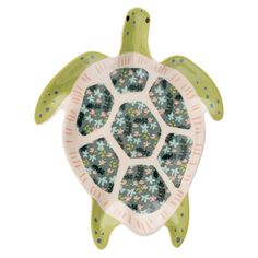 a green turtle shaped dish with flowers on it