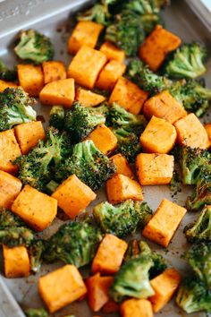 broccoli and sweet potatoes on a baking sheet