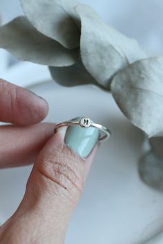 Sterling Silver Pebble Dot Stacking Ring. Made in the same style as my other tiny dot pieces, they all work together beautifully!  An ideal little treat that is perfect alone or as part of the dream stack. It's shown here with one of my birthstone rings, a tiny dot ring and of course a bee ring. Plenty of ideas there!  Made for you to your size from sterling silver wire and a perfect dot of recycled silver stamped with the letter of your choosing (or number!).  Ring sizers are available should you need to size your fingers.  *variety of rings shown as examples only. This listing is for one ring.  Packaged beautifully, ready to give or to enjoy! Minimalist Hand Stamped Midi Rings, Simple Stackable Initial Ring, Minimalist Hand Stamped Stackable Rings As Gift, Minimalist Hand Stamped Stackable Rings For Gift, Minimalist Hand Stamped Initial Ring As Gift, Dainty Hand-stamped Stackable Rings For Everyday, Dainty Tiny Initial Ring, Everyday Hand Stamped Stackable Rings, Minimalist Hand Stamped Rings For Everyday