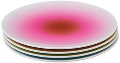 three plates stacked on top of each other with pink and green colors in the center