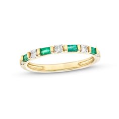 an emerald and diamond ring in yellow gold