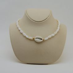 This beautiful choker is hand made with Cowrie seashell, mother of pearl beads cowrie sea shell choker necklace, natural shell All my jewelery is hand crafted with pure and 925 sterling silver , this is a safe way for you to store necklace will be sent along with a beautiful gift box and pouch Handmade White Shell-shaped Pearl Necklace, White Beaded Shell, White Strand Pearl Necklace For Vacation, Vacation White Strand Pearl Necklace, Handmade Pearl White Shell Necklace, White Beaded Choker For Vacation, Pearl White Beaded Shell Necklace, Handmade White Shell Necklace, Bohemian White Shell Pearl Necklace