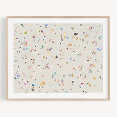 an art print with many different shapes and sizes on the paper, framed in a wooden frame