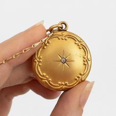 "This antique gold filled Edwardian or Victorian necklace features a photo locket pendant decorated in Art Nouveau repousse of a starburst around a paste gemstone. It hangs on n unusual and seemingly gold plated or filled chain. This item is not marked.   This locket measures about 1 1/8 inches in diameter (not including its bail) while its chain is about 24 inches long. The locket does not have locket frames or covers. It closes with a strong \"snap\"." Gold Heirloom Brass Locket Necklace, Heirloom Gold Brass Locket Necklace, Gold Necklace With Antique Finish For Keepsake, Heirloom Gold Pendant Locket Necklace, Heirloom Brass Locket Necklace, Heirloom Yellow Gold Jewelry With Antique Finish, Yellow Gold Amulet Locket Necklace As Gift, Gold Heirloom Locket Necklace With Intricate Design, Keepsake Yellow Gold Brass Locket Necklace