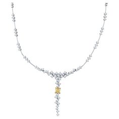 This beautiful and unique necklace features 5.30 carat total weight in white diamonds that drop with a 2.00 carat light fancy yellow radiant diamond at the center set in 18 karat yellow gold. The diamonds seem to float and are set in 18 karat white gold. This necklace features an adjustable box clasp closure with safety clasp. Measurements: The drop is approximately 2" White Diamond Necklace, The Bling Ring, Radiant Diamond, Diamond Jewelry Designs, Bling Rings, Drop Necklace, Unique Necklaces, Diamond White, Diamond Jewelry