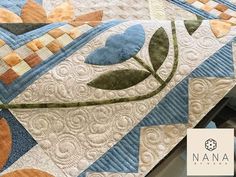 a close up of a quilt on a table with the words nanna written in white