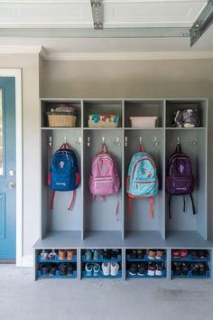 A modern garage mudroom with sleek, dark cabinetry, hooks, and a bench for stylish storage. Garage Mudroom Ideas, Gray Mudroom, Garage Lockers, Mudroom Ideas Diy, Laundry/mudroom Ideas, Kids Garage, Mud Room Garage, Functional Mudroom, Garage Entryway