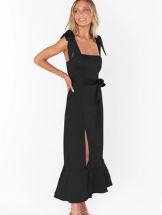 Make a daring statement in our AVIANCA Shoulder Tie Bridal Midi Dress in Black. This alluring bridal inspired midi dress features the signature AVIANCA shoulder tie detailing and rich claret fabric with a delicate shimmer, creating a sophisticated and exclusive look for the fashion-forward bride. Crafted with a luxurious feel, this dress is sure to dazzle on your special day or wedding guests. Size Guide: Model is 5’6” tall, and has a 33.4” bust, 26.5” waist, & 34.6” hips. She is wearing a S / U High Split Dress, Candle Dressing, Split Dress, Wedding Watch, Wedding Guests, Versatile Dresses, Black Midi Dress, Tank Shirt, Tank Top Shirt