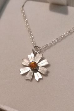 Simple and sweet, this dainty daisy flower necklace glows bright with golden citrine where each petal is hand-sculpted from sterling silver, textured, and soldered together to form this precious hand-crafted necklace. Delicate Sterling Silver Petal Jewelry, Handmade Sterling Silver Petal Jewelry, Dainty Amber Sterling Silver Jewelry, Sterling Silver Flower Birthstone Necklaces, Sterling Silver Flower Birthstone Necklace, Sterling Silver Flower Shape Birthstone Necklaces, Sterling Silver Flower-shaped Birthstone Necklaces, Yellow Daisy-shaped Jewelry Gift, Yellow Daisy Shaped Jewelry Gift