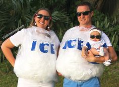 a man and woman dressed in plastic bags holding a baby