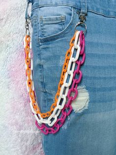 Rainbow Layered Pants Chain, Cute Wallet Chain, Rainbow Pride Color Plastic Chains, Kawaii Pocket Chains, Lesbian Flag Colors Layered orange, white and pink plastic chunky chain accessory. Super cute addition to your favorite outfit! A colorful way to express yourself. Based on the LGBTQIA+ flag colors. If you don't see your colors I would love to make them for you, just message me to start your order. See photos for size comparison with a ruler 📏 *Measurements based on length from clip to clip. The shortest chain is the one used for measuring as it's the best to determine how far it will reach on your body. The hanging layered chains are not measured, but you can see that they each get longer to create the stylish layered look.* I love using these chains as a pants chain or wallet chain. Rainbow Belt Chain, Pride Flag Outfit, Pansexual Outfit Ideas, Pride Accessories Diy, Pansexual Jewelry, Pansexual Pride Outfit, Pansexual Outfits, Cute Pride Outfits, Kidcore Accessories