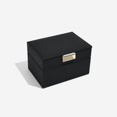 a black box with a gold handle on the top and bottom, sitting against a white background