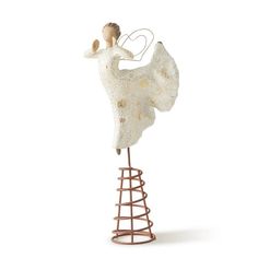 a figurine is standing on top of a wire structure and holding a heart