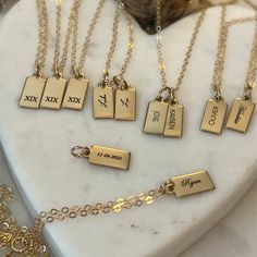 "Personalized Gold Rectangle Pendant Necklace from our Memoirs Made Collection. Personalize a short word or up to three initials on the lovely 14k gold filled tag necklace Free Engraving for a limited time! NECKLACE DETAILS * 14k gold-filled or 925 sterling silver * Matching cable chain in your choice of 16\", 18\" or 20\" length * Tag measures 13.5mm x 6mm (.53\" x .23\") * Spring ring clasp closure * Choice of several fonts and design layouts * 1 - 3 characters will fit across the tag, we can Customizable 14k Gold Necklaces For Anniversary Gift, Customizable 14k Gold Name Necklace For Anniversary, 14k Gold Name Necklace For Anniversary, Personalized Gold Necklaces With Meaningful Style, Meaningful Personalized Gold Necklaces, Gold Necklace With Name In Meaningful Style, Personalized Gold Necklace For Anniversary Gift, Personalized Gold Necklace For Anniversary, Custom Gold Name Necklace For Anniversary