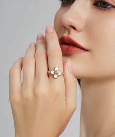 ✧ Material: 24K Yellow Gold Filled | 925 Sterling Silver ✧ Stone: White Mother of Pearl + Diamond Simulant Embrace the timeless allure of our 24K Gold Four Leaf Clover Ring, where elegance meets luck in a beautifully crafted piece of jewelry. Handcrafted with meticulous care, this ring is a true symbol of refined craftsmanship and enduring style. Craftsmanship and Materials: Each ring is meticulously crafted with a solid layer of 24K gold over a 925 sterling silver base, ensuring durability and Elegant Gold Plated Flower Ring For Anniversary, Elegant Gold Flower Ring With Rose Cut Diamonds, Gold Pearl Ring With Rose Cut Diamonds, Elegant Gold Pearl Ring With Rose Cut Diamonds, Elegant Yellow Gold Plated Flower Ring, Gold Sterling Silver Flower Ring With Rose Cut Diamonds, Luxury Yellow Gold Flower Ring With Gemstone, Luxury White Flower Promise Ring, White Gold Plated Rings Fine Jewelry