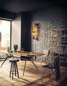 a dining room table with chairs and a brick wall behind it, in front of a window