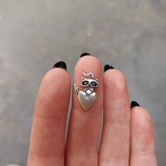 This adorable raccoon is peeking out from behind a heart.The charm is about 3/4 inch tall and 1/2 an inch wide. It has a nice weight/thickness to it and is very detailed for its size! Definitely a small charm, but substantial. Perfect gift for your raccoon obsessed friend, or for yourself!This charm comes on a 16 - 20 inch adjustable sterling silver chain OR as charm only, with no chain. Choose your option from the drop down menu.Each item comes in a cute box, without a receipt, ready for giving Cute Heart Shaped Silver Jewelry, Cute Silver Heart Shaped Jewelry, Cute Silver Heart Jewelry, Cute Sterling Silver Heart Pendant Jewelry, Cute Silver Heart-shaped Jewelry, Cute Silver Heart Pendant Jewelry, Silver Novelty Charm Necklace, Racoon Earrings, Racoon Keychain