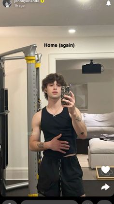 a man taking a selfie in front of a mirror with the caption home again