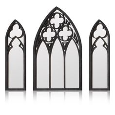 three black stained glass windows with flowers on them