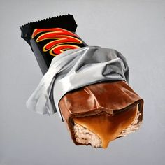 a piece of chocolate covered candy sitting on top of a white countertop next to a gray wall