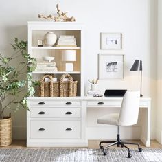 a white desk and chair in front of a bookshelf with pictures on the wall