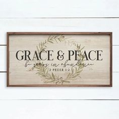 a wooden sign that says grace and peace on the side of a white wood wall