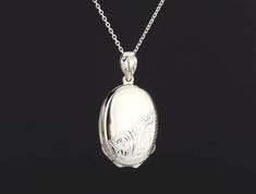 "Custom engraved oval four photo locket,custom engraving,personalized memorial locket,mother's day gift,remembrance jewelry,anniversary locket with photos Perfect as a Mother's Day gift, this custom engraved four photo locket necklace has: 1. One shining, highly polished sterling silver locket (26 x 19mm, 11.5 grams). It is also a bit heavy with 4 locket leaves inside.     It can be engraved on the front and back (use pulldown menu to select)     The front has its bottom half etched with a flora Elegant Oval Pendant Locket Necklace For Keepsake, Elegant Medallion Locket Necklace For Anniversary, Engraved Oval Link Locket Necklace For Wedding, Elegant Etched Oval Pendant Locket Necklace, White Gold Sterling Silver Oval Pendant Locket Necklace, Silver Oval Necklace For Anniversary Gift, Silver Oval Necklace For Anniversary, Classic Memorial Locket Necklace With Polished Finish, Classic Anniversary Locket Necklace With Engraving Option