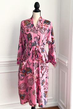 This robe is more than just loungewear; it's a statement piece that combines comfort with fashion. The half calf  dressing gown provides a cozy and stylish layer, whether enjoying a laidback morning with a cup of tea or winding down in the evening after a joyful day of holiday celebrations. The Kimono Robes showcase vibrant artistic prints on 100% soft cotton fabric, Indian print the fabric is print dyes are  eco-friendly dyes. These beautiful cotton robes come with large pockets with belt and a Printed Pink Sleepwear For Home, Pink Printed Sleepwear For Home, Pink Cotton Nightgown For Lounging, Spring Long Robe For Home, Long Spring Robe For Home, Long Sleeve Robe For Lounging, Spring Wrap Loungewear Robe, Spring Lounging Wrap Sleepwear, Pink Bohemian Kimono For Loungewear