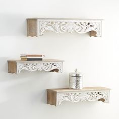 two white wooden shelves on the wall