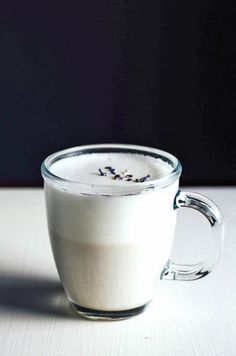 a glass cup filled with liquid sitting on top of a table