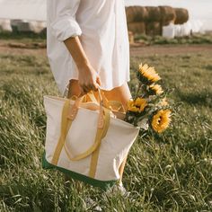 Cotton canvas tote features a convenient zipper closure and an exterior pocket, making it the ideal bag for everyday adventures. sold individually converts from handheld to shoulder with detachable leather handles brass zipper closure once the handles are removed, the tote is washable all seams are double-stitched and bound with cotton on the inside one interior pocket and one exterior pocket leather will patina over time with exposure to the sun and the oils in your skin hand wash with cold wat Large Capacity Top Handle Canvas Bag For On-the-go, Cotton Shoulder Bag With Zipper For On-the-go, Canvas Weekender Bag With Double Top Handles, Everyday Tote Weekender Bag With Canvas Lining, Duck Canvas Tote Bag With Canvas Lining, Double Handle Cotton Canvas Bag For Travel, Canvas Tote Bag With Top Carry Handle For Travel, Everyday Tote Satchel With Canvas Lining, Everyday Satchel Tote With Canvas Lining