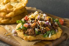 an open faced pizza on a cutting board next to some fries