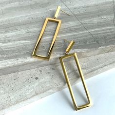 New~ Anthropologie Gold Rectangle Silhouette Earrings This Is A Perfect Pair Of Earrings To Add To Your Collection. Their Elegant And Modern Design Is Timeless. Suspended From A Tiny Gold Rectangle, A Larger See Through Golden Frame Dangles Below Reflecting Light From All Surfaces. With Their Long Silhouette And Clean Lines, These Can Be Worn Anytime. Approx. Size, 2-1/4"L, 1/2" W. Gold Plated, Nwot. Anthro Style, Boho Style, Trendy, Brand New Anthropologie Jewelry, Everyday Hoop Earrings, Gold Everyday Modern Rectangular Linear Earrings, Rectangular Linear Earrings For Gift, Gold Rectangular Linear Earrings For Everyday, Modern Rectangular Earrings For Party, Modern Rectangular Party Earrings, Elegant Rectangular Linear Earrings For Gift, Elegant Rectangular Linear Earrings As Gift, Rectangular Metal Earrings For Everyday, Chic Rectangular Earrings As Gift