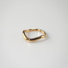 Highly polished and plated with 18k gold, the Single Wave Ring curves like a dancer with smooth movement. Each curve is lovingly crafted to create an individual gesture. Wear it solo for minimal style or dual and triple for a statement look. 18k gold plated Stainless steel base Waterproof and tarnish free Available in Minimalist Curved Gold Jewelry, Modern Gold Rings With Curved Design, Modern Gold Curved Rings, Modern Curved Gold Rings, Gold Curved Rings For Gifts, Curved Gold Rings For Gifts, Gold Curved Rings For Gift, Sleek Gold Ring For Gift, Gold Curved Rings With Polished Finish