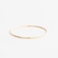 The Double Weight Gold Hoop Bangle In Minimalist Style, Minimalist Gold Hoop Bangle, Minimalist Gold Hoop Bracelet, Minimalist Stackable Hoop Bangle, Minimalist Stackable Round Bangle, Minimalist Stackable Round Band Bracelets, Minimalist Stackable Bracelets With Round Band, Classic 14k Gold Hoop Bangle, Everyday 14k Gold Hoop Bracelets