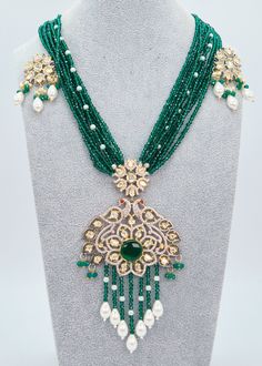 "Tyaani Kundan Double Peacock Mala Necklace/Emerald Green Long Necklace Set/Indian Jewelry/Rani Haar/Bridal Necklace Set/Pakistani Jewelry Enhance your special event with the mesmerizing Emerald Green necklace set that showcases Kundan embellishments and a mala made of hydro beads. Make sure to grab this exquisite jewelry piece before it's too late! Necklace Length: 16\" Neckline has an adjustable doori. Earring Lenght: 2\" Push-Back closure Weight : 12 gms each. Dual-tone finish on high-quality brass as a base metal. Availability: In-Stock. *Color may vary slightly due to light condition & photography. Jewelry Care:  Keep away from moisture. Allow perfumes and lotion to dry before wearing. Store in jewelry pouch. Clean only with soft lint-free cloth.  At Sparkling Trendz, we offer a wide Green Bollywood Necklace With Peacock Design, Emerald Kundan Necklace With Intricate Design For Festive Occasions, Green Bollywood Necklaces With Peacock Design, Festive Emerald Kundan Necklace With Intricate Design, Festival Necklaces With Stone Work, Festive Chandbali Kundan Necklace With Emerald, Festive Emerald Kundan Chandbali Necklace, Festive Emerald Kundan Necklace With Stone Work, Green Necklace With Peacock Design For Diwali