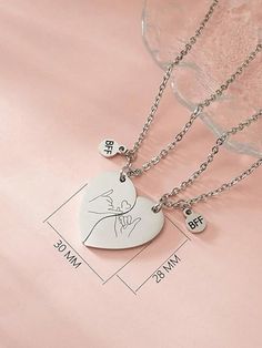 two necklaces that are on top of a pink sheet with the names of people