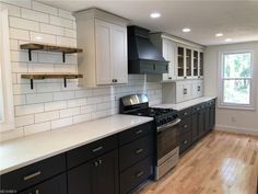 an empty kitchen with white and black cabinets