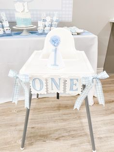 a blue and white baby's first birthday party with a one cake on the table