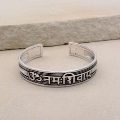 About item Item :-  Kriya Bangles Kada Ring size :- Chose from variation (Custom size accepted) Material  :- German Silver, Brass Title:-Om Namah Shivay Sacred Bracelets, Mantra Bracelet "Aum Namah Shivay "Open Face Cuff Bangle, Sacred Bracelets for Spiritual Bliss, Yoga Gifts, God Shiva bangles, Om Spiritual Jewelry, Valentine's day gift, Christmas day gift Description:- We accept all types of custom & personalized order. Please send us a message if you are interested in a custom creation. What Adjustable Spiritual Bracelets For Festivals, Adjustable Silver Bracelets For Festivals, Adjustable Bracelets For Meditation And Festivals, Silver Spiritual Bangle For Festivals, Handmade Adjustable Spiritual Bangle, Symbolic Festival Bangle Bracelet, Silver Adjustable Spiritual Bracelets, Adjustable Silver Spiritual Bracelets, Adjustable Silver Spiritual Bracelet